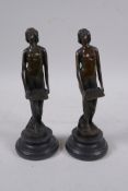 A pair of Art Nouveau style bronze figures of women carrying trays, 19cm high