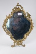 A brass rococo style easel mirror with winged dragon decoration, 44cm high