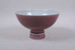 A Chinese puce glazed porcelain bowl with ribbed foot, Qianlong seal mark to base, 19cm diameter