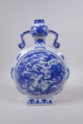 A blue and white porcelain two handled garlic head shaped flask decorated with a dragon and phoenix,