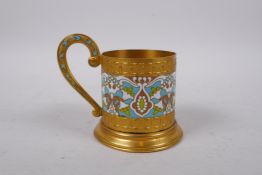 A Russian gilt metal and enamel beaker holder, stamped to the base, 8 cm diameter