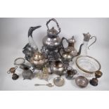 A quantity of silver plated items to include a spirit kettle on stand, claret jugs and a