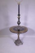 A 'Hollywood Regency' metal floor lamp with glass top table, decorated with a parcel gilt and