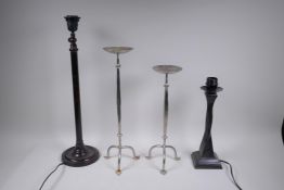 A plated pricket candle stick and another, smaller, together with two bronze table lamps, largest