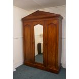 A Victorian mahogany mirrored door wardrobe, fitted with a hanging cupboard and four slide drawers