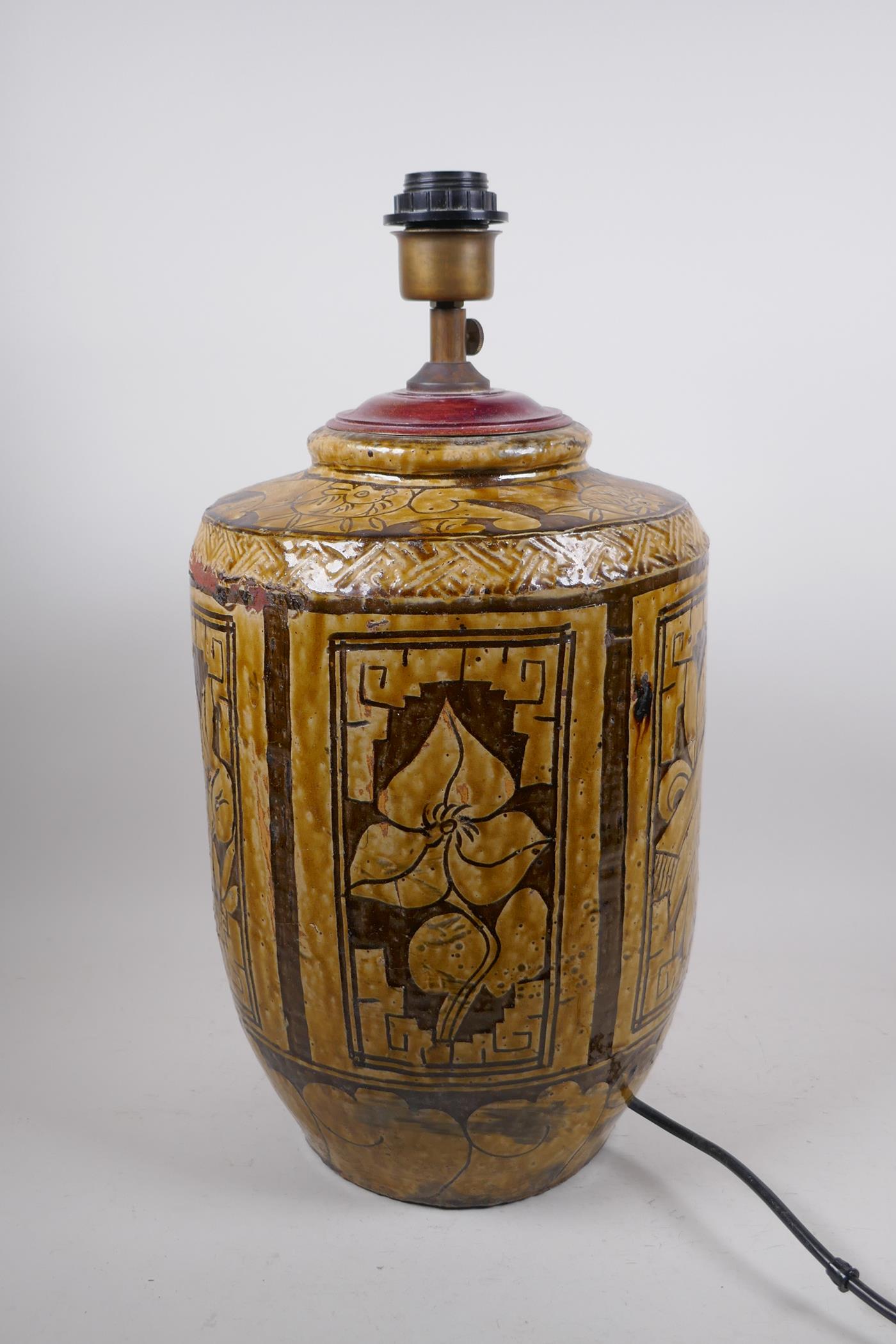 A C19th Chinese Cizhou kiln pottery jar, with decorative floral panels and bats, converted to a