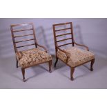 A pair of Edwardian inlaid walnut bedside/nursing chairs with ladder backs and open arms, raised