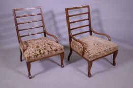 A pair of Edwardian inlaid walnut bedside/nursing chairs with ladder backs and open arms, raised