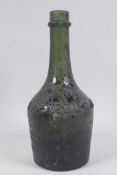 An antique Benedictine glass bottle, 23cm high