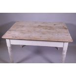 A Victorian pine scullery table with scrubbed top and painted base, raised on turned supports, 122 x