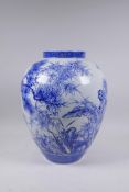 A Japanese blue and white porcelain vase decorated with Asiatic flora, 35cm high, chip to rim