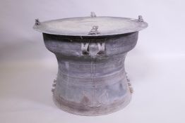 A C19th Burmese bronze rain drum with waisted base, the top and side with cast concentric bands,