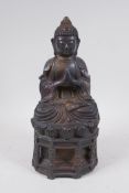 A Chinese bronze figure of Buddha seated in prayer, inscription verso, 30cm high