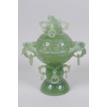 A C19th Chinese carved celadon jade censer and cover, with dragon and free ring decoration, 18cm