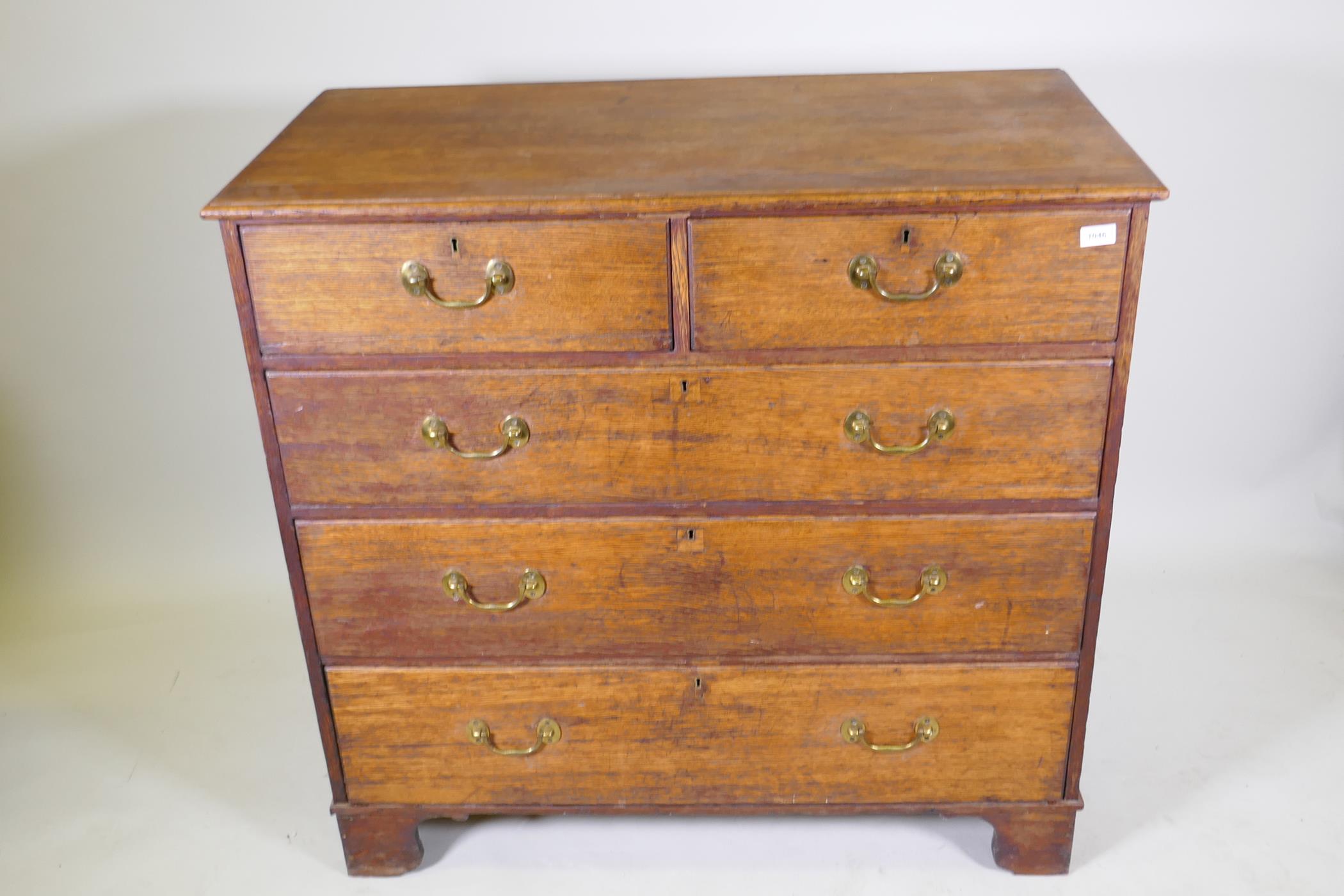 A George III oak chest of two over three drawers with brass handles, raised on bracket supports, 110 - Image 2 of 4