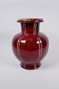 A Chinese flambe glazed porcelain vase of lobed form, 25cm