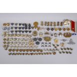 A collection of military buttons, badges, pins etc