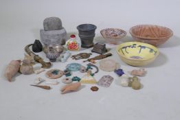 A collection of Middle Eastern artefacts, a Bactrian idol, terracotta bowls, Islamic beads and