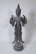 A Burmese finely cast bronze figure of eight armed Shiva bearing Hindu totems in each hand, possibly