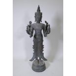 A Burmese finely cast bronze figure of eight armed Shiva bearing Hindu totems in each hand, possibly