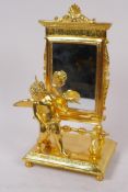 A ormolu table mirror in the form of an easel with cherubic figure, 24cm high