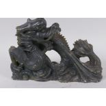 A Chinese carved soapstone figure of a fire breathing dragon, 16cm high