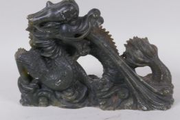 A Chinese carved soapstone figure of a fire breathing dragon, 16cm high