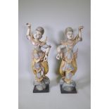 A pair of Indian carved and painted hardwood figures of dancers, 117cm high