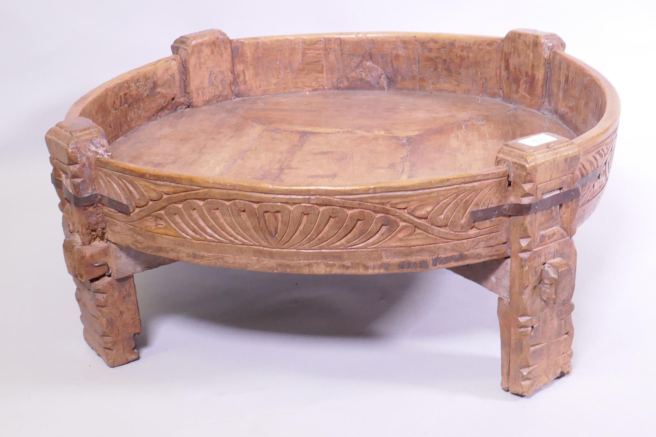 A South East Asian carved fruitwood low trough table, with metal straps, 80cm diameter x 29cm high - Image 2 of 4