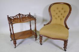 A Victorian walnut two tier occasional table with carved and pierced three quarter gallery top and