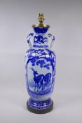 A Japanese blue and white porcelain two handled vase decorated with birds, deer and dragons, late