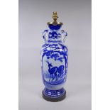 A Japanese blue and white porcelain two handled vase decorated with birds, deer and dragons, late