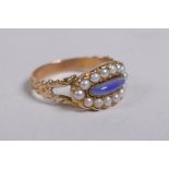 An antique gold mourning ring, set with seed pearls around a blue stone, size P/Q
