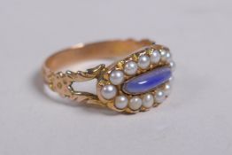 An antique gold mourning ring, set with seed pearls around a blue stone, size P/Q
