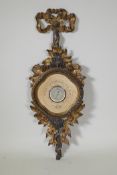 A continental carved and gilt wood cased barometer, with ribbon crest and leaf and flower