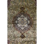 A Persian gold ground silk carpet with all over floral design and central medallion, 183 x 290cm