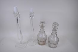 A pair of Georgian three ring neck decanters with star cut decoration, 27cm high, and a near pair of