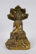 A Chinese gilt bronze figure of Buddha seated as a mythical creature, 6 character mark to vase, 27cm