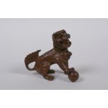 A Japanese bronze okimono temple lion, 6cm high