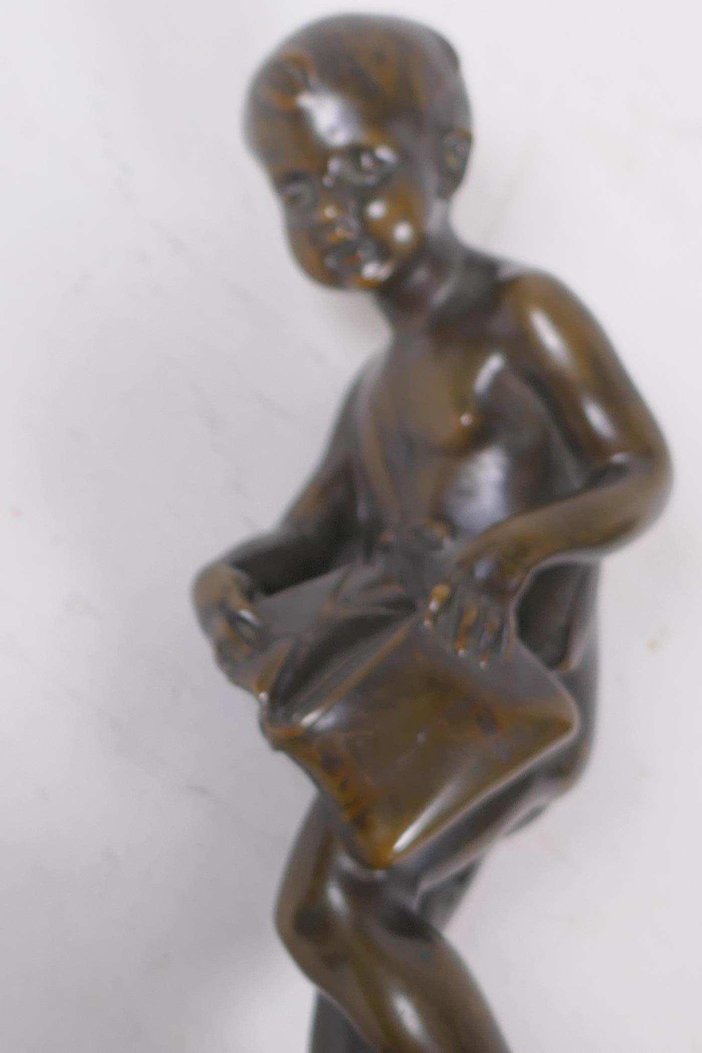 A bronze figure of Cupid delivering love letters,  raised on a turned marble socle, 28cm high - Image 5 of 5