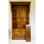 An oak open bookcase over two cupboard doors, 106 x 34cm, 205cm high