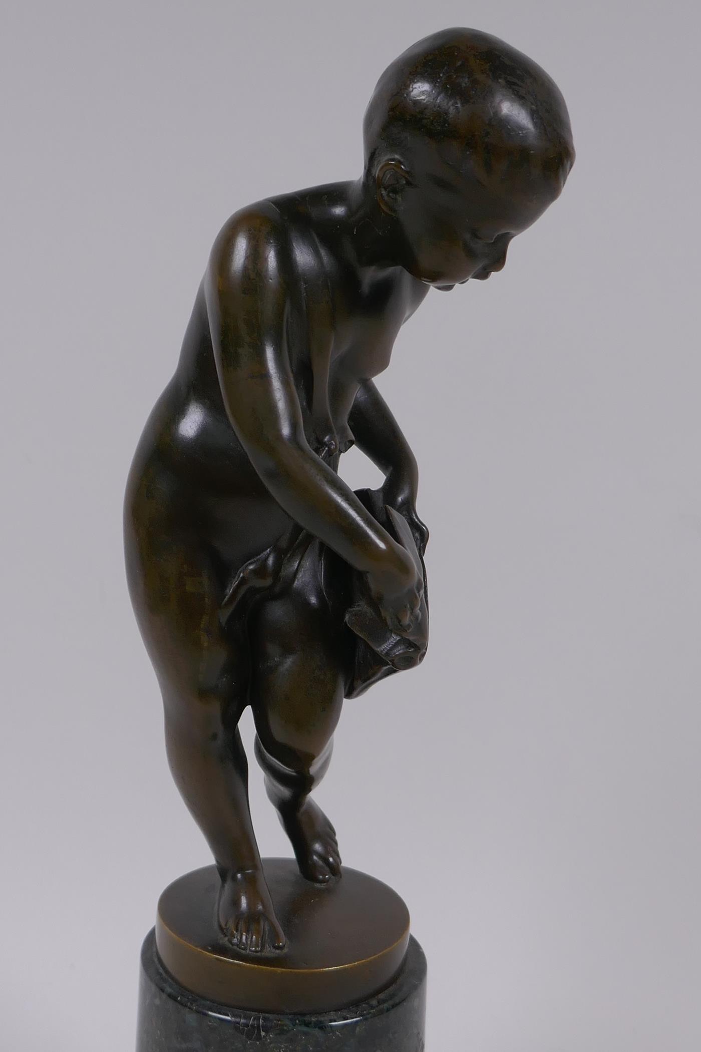 A bronze figure of Cupid delivering love letters,  raised on a turned marble socle, 28cm high - Image 3 of 5