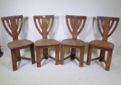 A set of four oak Arts and Crafts chairs