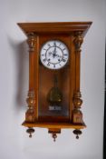 A Vienna walnut cased wall clock, the enamel chapter dial with Roman numerals, and movement striking