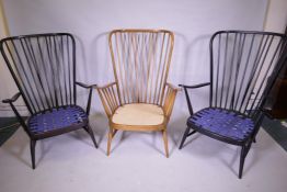 A pair of vintage Ercol stained beech 'Evergreen' armchairs, and another in a natural finish, one