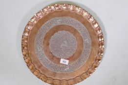 A Middle Eastern, North Indian heavy gauge copper tray inlaid with silver decoration depicting deer,