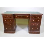 A Victorian walnut nine drawer kneehole desk with inset top (AF) raised on a plinth base, 137 x 45 x