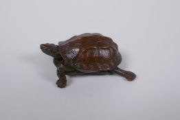 A Japanese Jizai style bronze okimono tortoise with an articulated head and tail, 5cm long