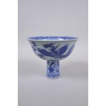 A Chinese blue and white porcelain stem bowl with phoenix decoration, 14cm diameter