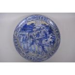 A Chinese blue and white porcelain charger decorated with ladies in a garden, with flower and